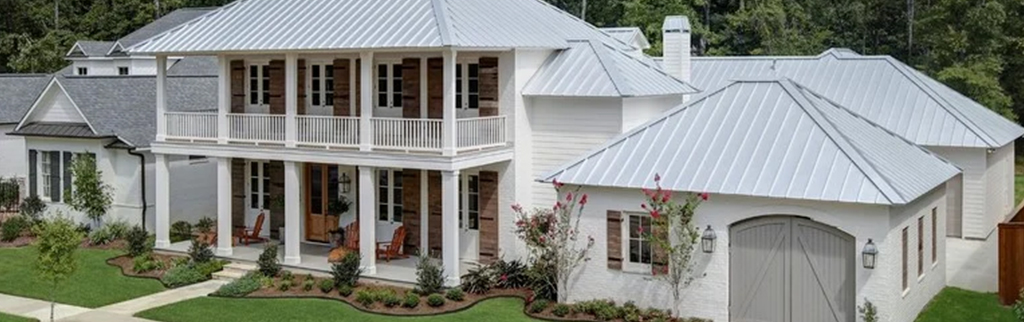 A white home in Florida with a light color stone coated metal roof