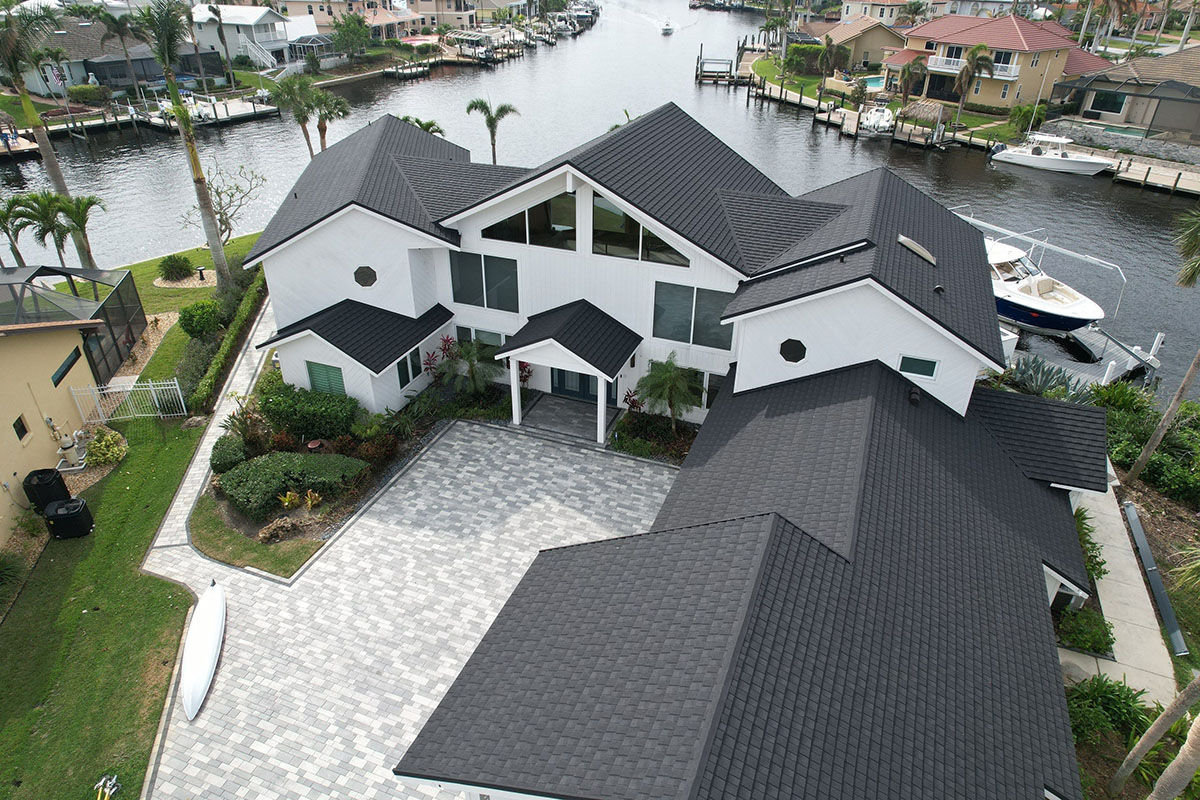 Aerial view of white home with dark Tilcor CF shingles installed