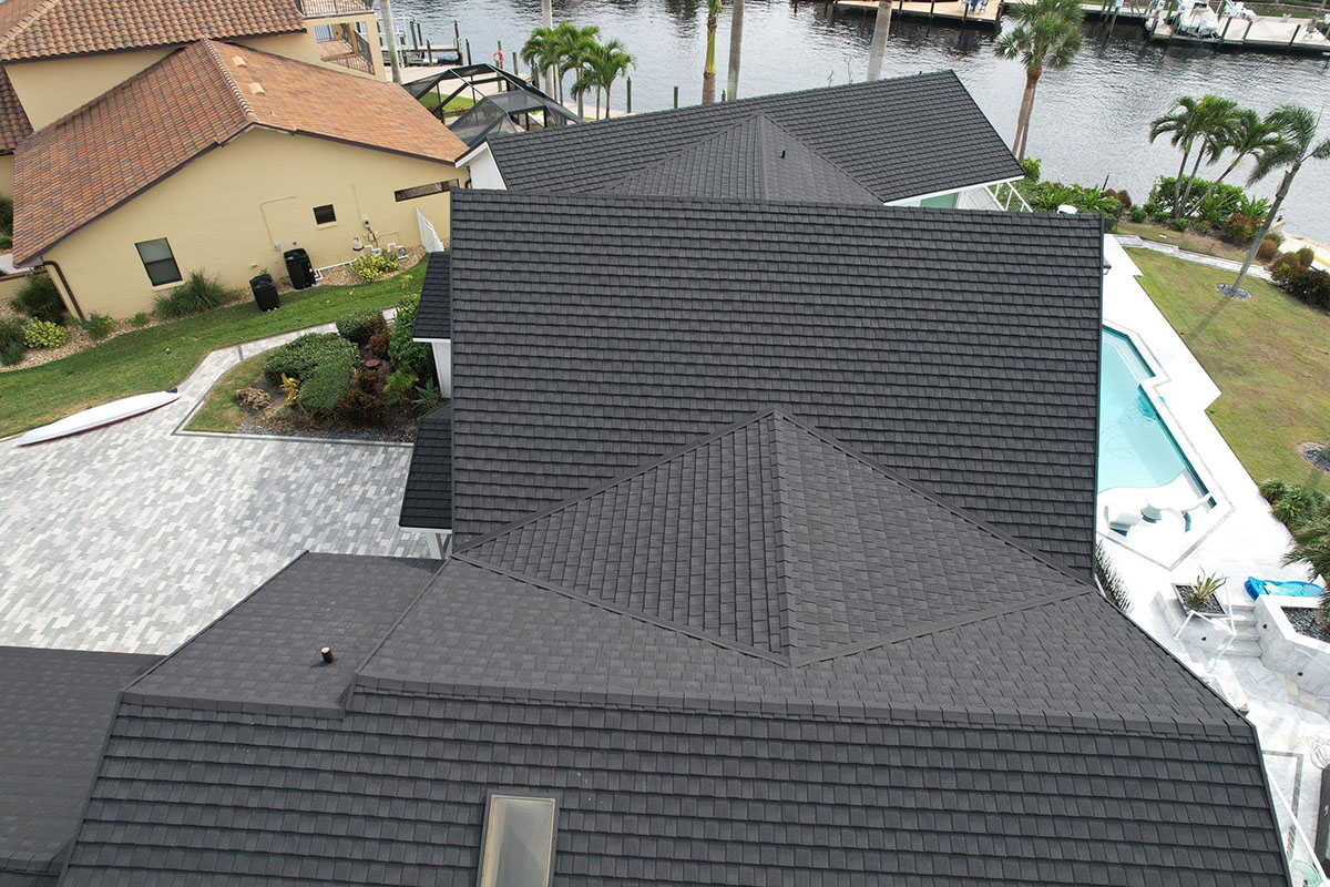 Aerial view of white home with dark Tilcor CF shingles installed