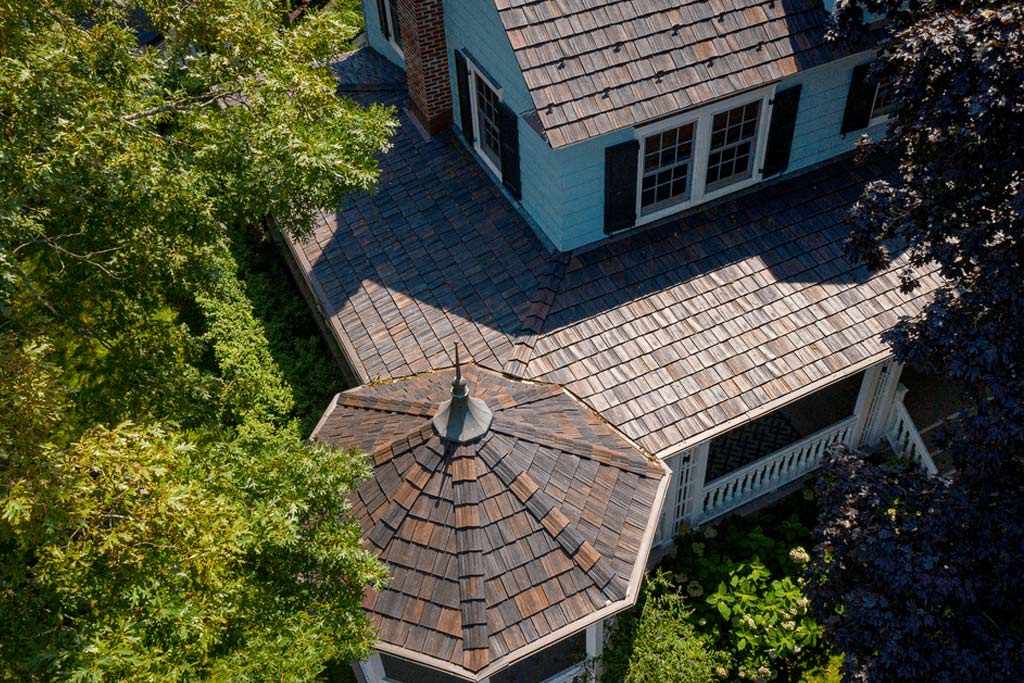 Aerial view of blue home with grey Brava Roofing system installed in Florida