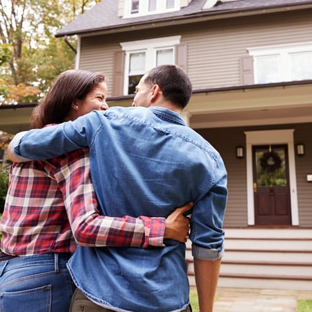 A couple walking into a home