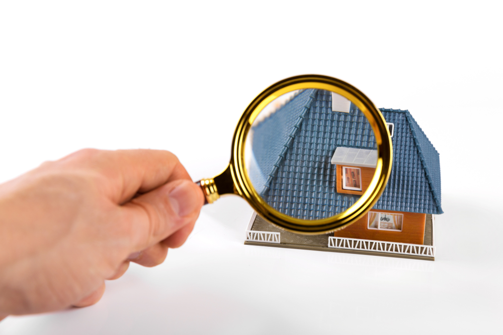 Graphic of a magnifying glass looking at a model home