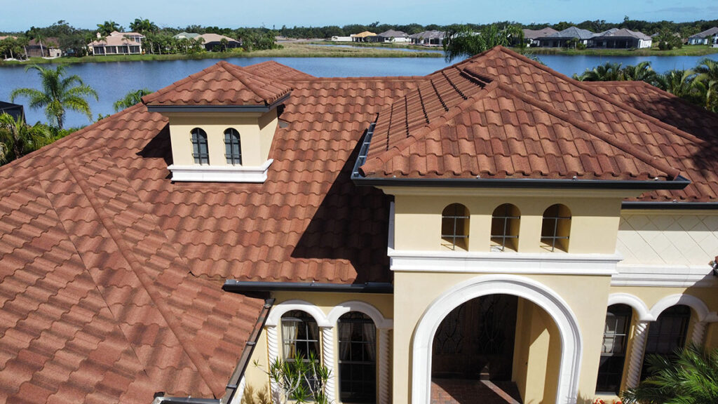 An arial view of a house with a brown mediterranean styled roof.